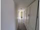 Hallway featuring wood look floors, and white cabinets offering ample storage at 3143 W Glendale Ave, Phoenix, AZ 85051