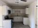 Updated kitchen featuring modern white cabinets and countertops at 3143 W Glendale Ave, Phoenix, AZ 85051