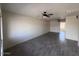 Open-concept living room featuring new flooring and a ceiling fan at 3143 W Glendale Ave, Phoenix, AZ 85051