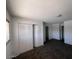 Bedroom with closet with sliding doors, carpet, and view of hall at 4332 W Ocotillo Rd # 206, Glendale, AZ 85301