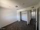 Bedroom with dark carpet, a closet with doors and neutral walls at 4332 W Ocotillo Rd # 206, Glendale, AZ 85301