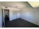 Bedroom with dark carpet, closet with sliding doors, and a neutral wall color at 4332 W Ocotillo Rd # 206, Glendale, AZ 85301