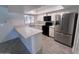 Bright kitchen featuring modern appliances, quartz countertop, and white cabinets at 4332 W Ocotillo Rd # 206, Glendale, AZ 85301
