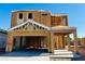 Framed two-story home under construction with a garage and covered entry on a clear day at 4977 E Umber Rd, San Tan Valley, AZ 85143