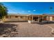 The backyard features a covered patio with access to the house, gravel ground covering, and blue skies at 509 N 56 St, Mesa, AZ 85205