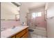 Bathroom features vanity, sink, and shower with decorative swan sliding glass door at 509 N 56 St, Mesa, AZ 85205