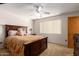 Comfortable bedroom with plush carpeting, ceiling fan, and natural light at 509 N 56 St, Mesa, AZ 85205