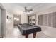 Spacious game room featuring tiled flooring and pool table, perfect for entertaining guests at 509 N 56 St, Mesa, AZ 85205
