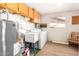 Laundry room features a sink, cabinetry for storage, and window providing natural light at 509 N 56 St, Mesa, AZ 85205