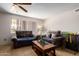 Cozy living room featuring plush couches, a ceiling fan, and a bright window at 509 N 56 St, Mesa, AZ 85205
