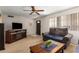 Comfortable living room featuring a ceiling fan, carpet, and a fireplace at 509 N 56 St, Mesa, AZ 85205