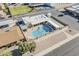 Aerial view showcasing the community pool, spa, clubhouse, and manicured green spaces, offering a resort-like experience at 6433 E University Dr, Mesa, AZ 85205