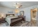 Comfortable bedroom with wood flooring, ceiling fan, and ensuite bathroom access at 6433 E University Dr, Mesa, AZ 85205