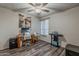 Bedroom features wood floors, ceiling fan, desk, and natural light at 6433 E University Dr, Mesa, AZ 85205
