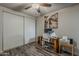 Bedroom features wood floors, ceiling fan, and desk at 6433 E University Dr, Mesa, AZ 85205