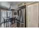 Cozy dining area features a ceiling fan, modern wood flooring, and stainless steel refrigerator at 6433 E University Dr, Mesa, AZ 85205