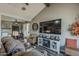 Spacious living area with a large screen TV, fireplace, and comfortable seating, perfect for entertaining and relaxation at 6433 E University Dr, Mesa, AZ 85205