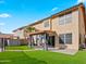 Landscaped backyard with covered patio, artificial turf, and block fence at 12547 W Edgemont Ave, Avondale, AZ 85392