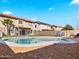 Backyard with swimming pool, rock landscaping, artificial grass, and privacy fence at 12547 W Edgemont Ave, Avondale, AZ 85392