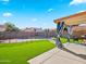 Backyard featuring covered patio, artificial turf, and a fenced swimming pool at 12547 W Edgemont Ave, Avondale, AZ 85392