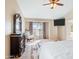 Bright bedroom showcasing a large window, carpeted floor, and dark wood furniture at 12547 W Edgemont Ave, Avondale, AZ 85392