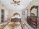 Inviting main bedroom featuring a ceiling fan, carpeted floor, and dark wood furnishings at 12547 W Edgemont Ave, Avondale, AZ 85392