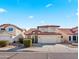 Inviting two-story home featuring a red tile roof, well-manicured landscaping, and a welcoming facade at 12547 W Edgemont Ave, Avondale, AZ 85392