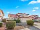 Two-story home featuring manicured landscaping, a tile roof, and a two-car garage at 12547 W Edgemont Ave, Avondale, AZ 85392