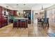 Open kitchen showcasing a center island with bar seating, dark cabinets and stainless steel appliances at 12547 W Edgemont Ave, Avondale, AZ 85392