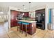 Well-appointed kitchen featuring a center island, dark wood cabinetry, granite counters and stainless steel appliances at 12547 W Edgemont Ave, Avondale, AZ 85392