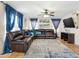 Comfortable living room featuring a large leather sectional sofa, ceiling fan and tiled flooring at 12547 W Edgemont Ave, Avondale, AZ 85392