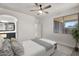 Bright bedroom with a ceiling fan, a view to the bathroom, and a cozy, light-filled ambiance at 1380 W Angus Rd, San Tan Valley, AZ 85143