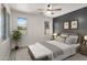 Serene bedroom with neutral tones, decorative pillows, and ample natural light, perfect for relaxation at 1380 W Angus Rd, San Tan Valley, AZ 85143