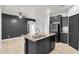Spacious kitchen with stainless steel appliances, dark cabinetry, and a central island for efficient cooking and dining at 1380 W Angus Rd, San Tan Valley, AZ 85143