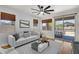 Comfortable living room featuring a sliding glass door to the backyard and plenty of natural light at 1380 W Angus Rd, San Tan Valley, AZ 85143