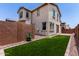 Backyard with artificial turf, gravel landscaping and privacy walls at 14241 W Bronco Trl, Surprise, AZ 85387