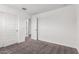 Neutral carpeted bedroom with white walls and a view of a hallway with white doors at 14241 W Bronco Trl, Surprise, AZ 85387