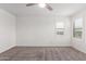 Bright bedroom with a ceiling fan and two shuttered windows at 14241 W Bronco Trl, Surprise, AZ 85387
