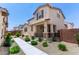 Charming two-story home featuring a welcoming front porch and well-maintained landscaping at 14241 W Bronco Trl, Surprise, AZ 85387