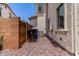 House exterior featuring gravel landscaping, privacy walls, and an air conditioning unit at 14241 W Bronco Trl, Surprise, AZ 85387