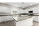 Beautifully designed kitchen with white cabinets, granite countertops, and an island at 14241 W Bronco Trl, Surprise, AZ 85387