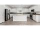 Modern kitchen with stainless steel appliances, granite countertops, and a center island at 14241 W Bronco Trl, Surprise, AZ 85387