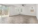 Bright living room with wood-style tile flooring, lots of natural light, and neutral paint at 14241 W Bronco Trl, Surprise, AZ 85387