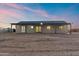 Backyard view of single-story home featuring a covered patio and desert landscaping at 15582 W Jomax Rd, Surprise, AZ 85387