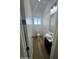 Powder room featuring a modern vanity with vessel sink and wood-look floors at 15582 W Jomax Rd, Surprise, AZ 85387
