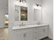 Primary bath with double sinks with stone countertops and views of the outdoors at 15582 W Jomax Rd, Surprise, AZ 85387