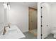 Primary bath featuring double sinks, stone countertops, and a glass enclosed shower at 15582 W Jomax Rd, Surprise, AZ 85387