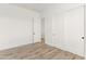 Bright bedroom features wood-look floors and a large closet with sliding doors at 15582 W Jomax Rd, Surprise, AZ 85387