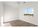 Bright bedroom features a ceiling fan and a large window with a view of trees at 15582 W Jomax Rd, Surprise, AZ 85387