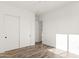 Bright bedroom features wood-look floors and a large closet with sliding doors at 15582 W Jomax Rd, Surprise, AZ 85387